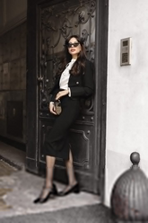 a lady in a white shirt, a black blazer and a black slit long skirt